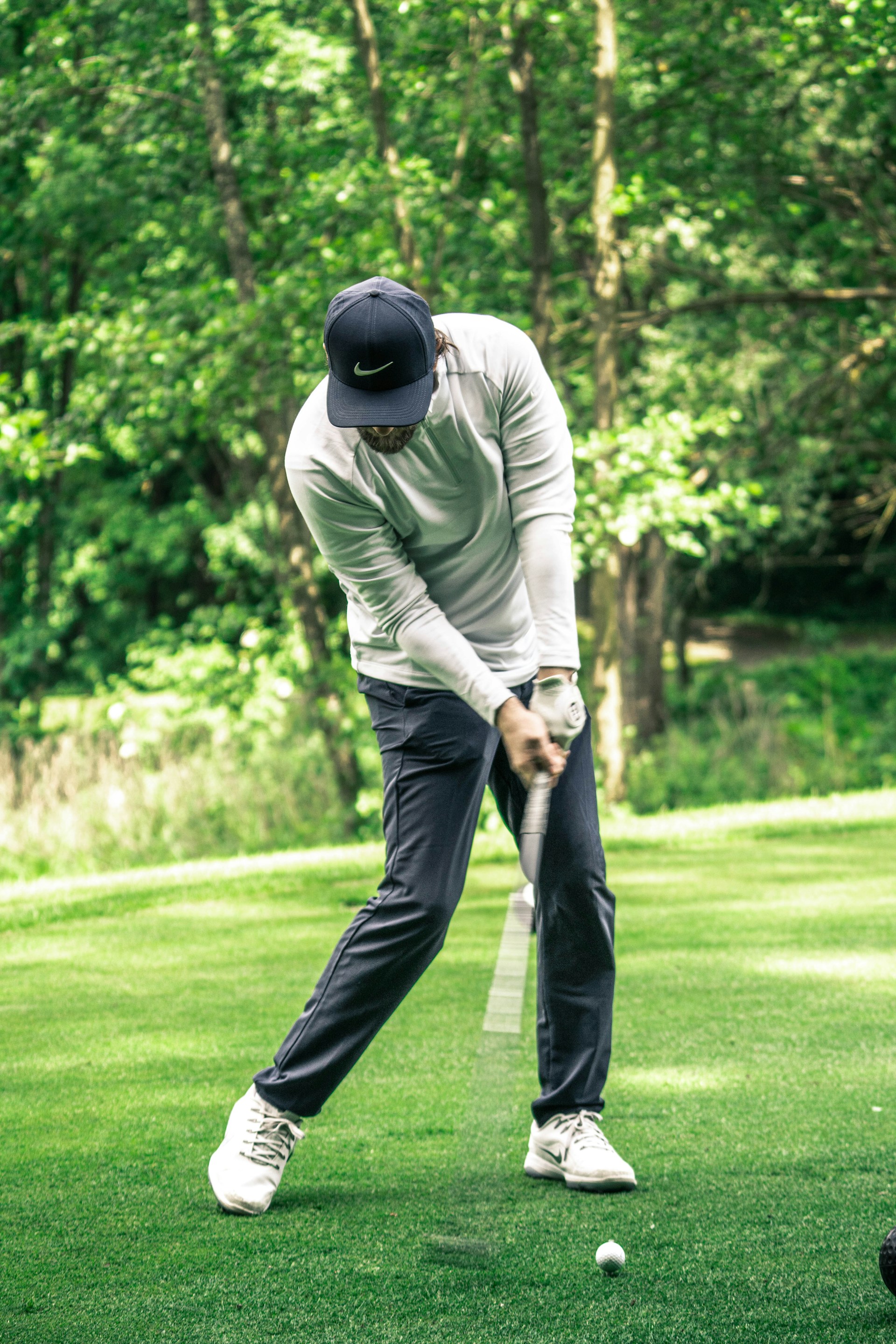 Golfer mid-swing on course